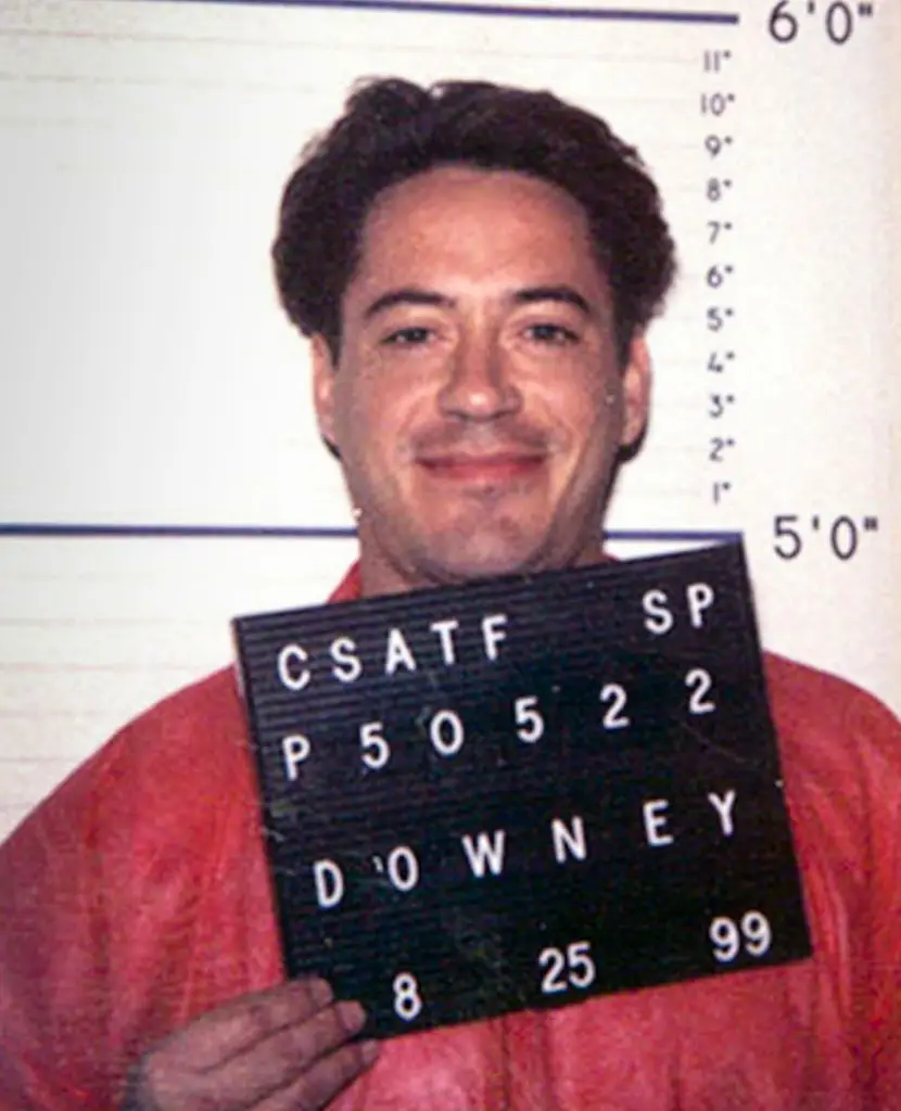 Robert Downey Jr in orange jumpsuit for a photo