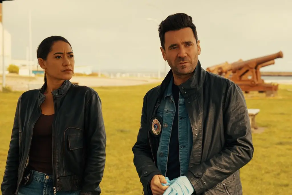 two police officers in leather jackets outside