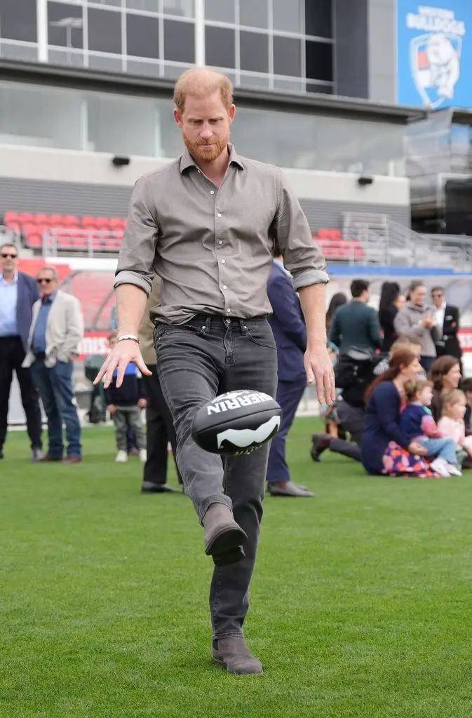 Prince Harry kicks the football
