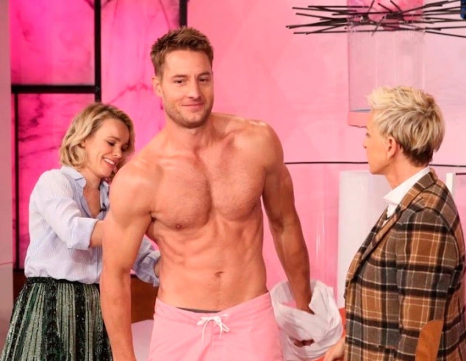 man presenting a muscular person wearing swim shorts accompanied by two people