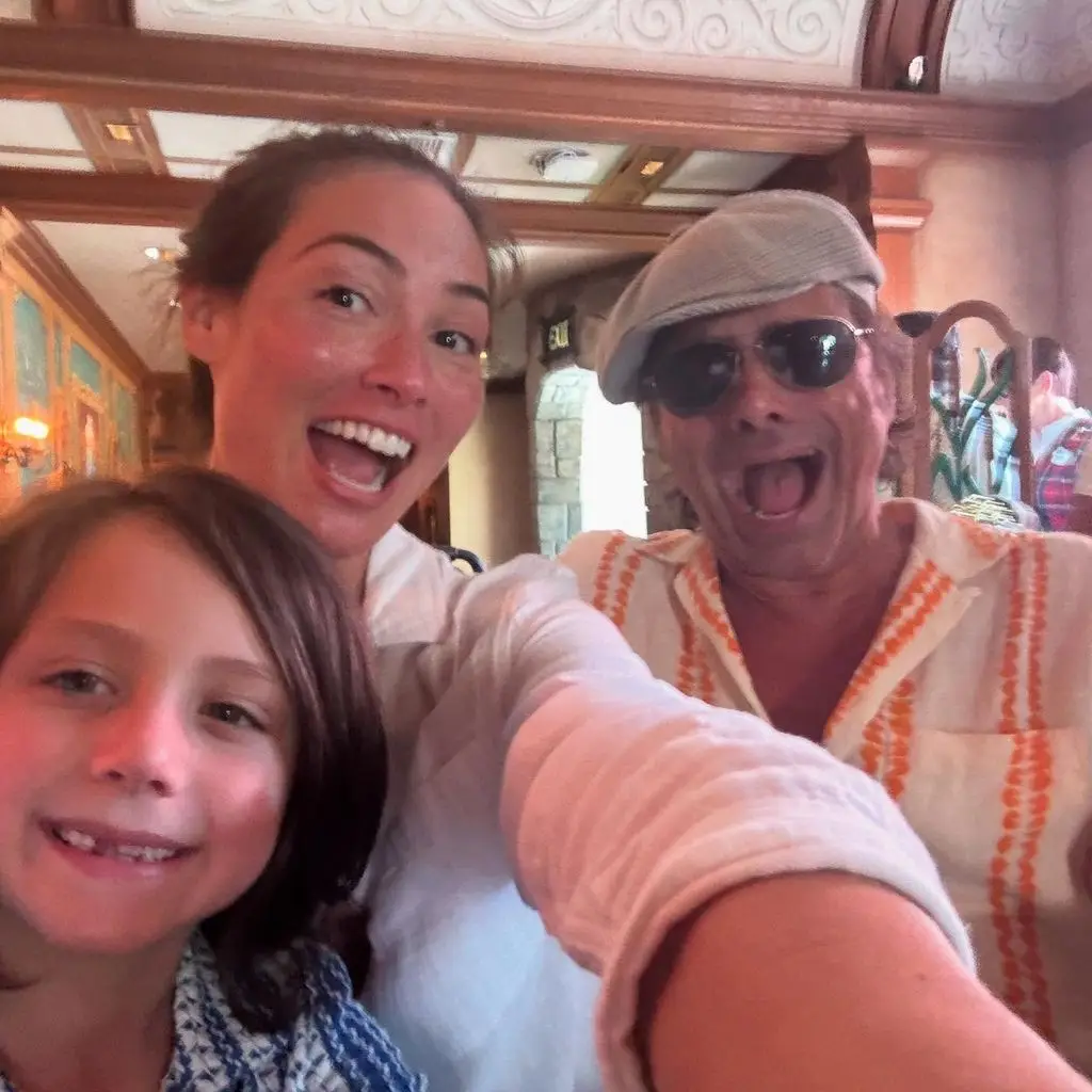 John Stamos smiling in a photo with his wife and son