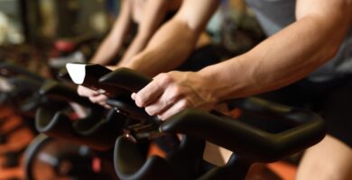 close up of hands of a man biking in the gym KPWTYO7CQZGN7NIZIDEHJG7A6E