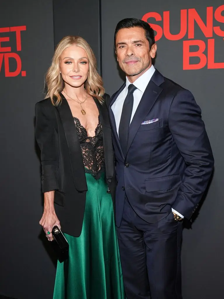Kelly Ripa Exposes Ryan Seacrest's 'Fixed' Wardrobe Malfunctions Reside On Air 2 Kelly Ripa in black blazer and lace dress and Mark Consuelos in navy suit