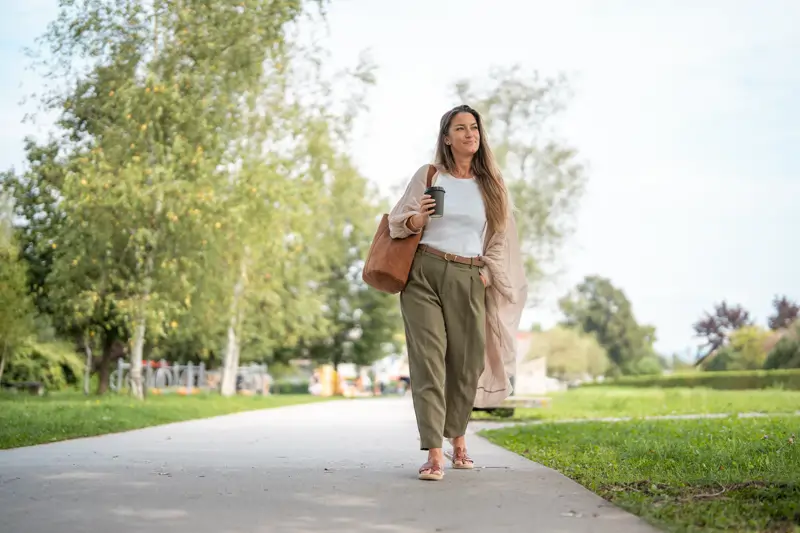Woman walking in a park.