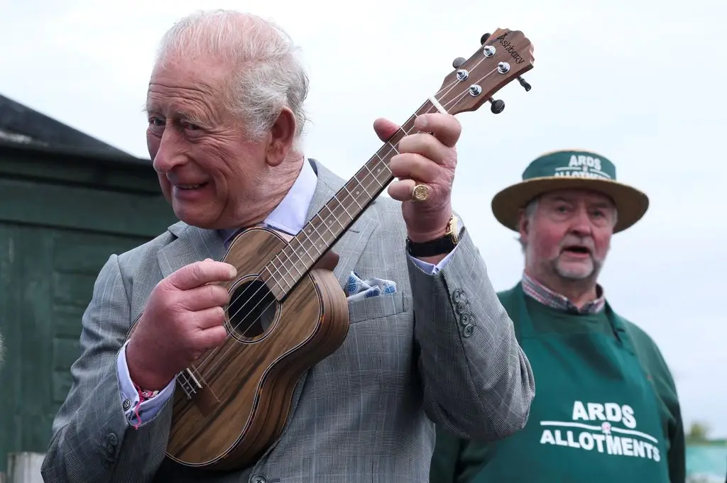 King Charles playing the ukulele