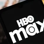 The HBO Max logo is seen displayed on a smartphone screen.