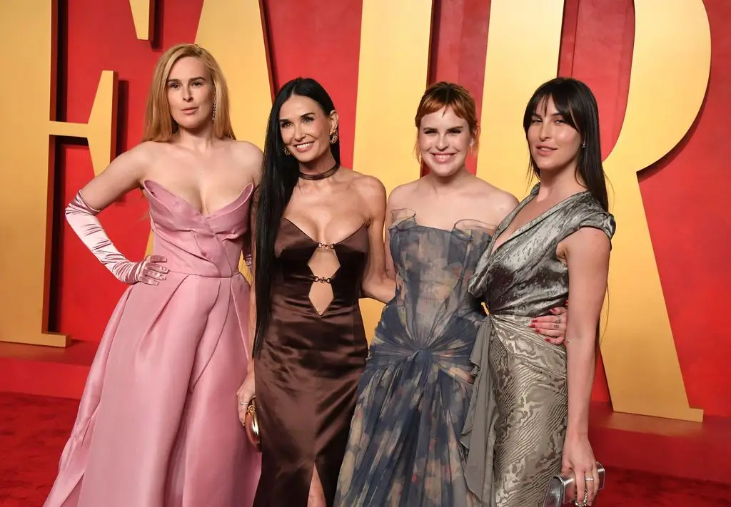 Demi Moore's Daughter Tallulah Highlights Her Mother's Spectacular Transformation in Then and Now Photographs 1 Demi Moore with her three daughters at the 2024 Vanity Fair Oscars party