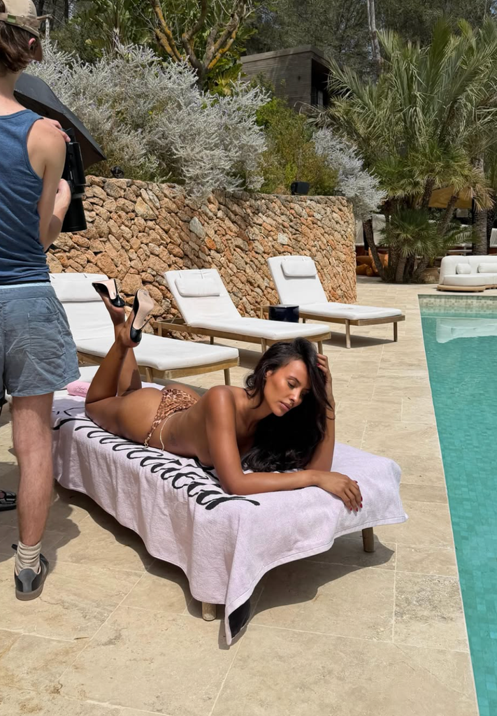 Maya Jama is all legs and poses as a scorching summer time pin-up in a tiny swimsuit and sky-high heels. 2 A photo of Maya Jama wearing a leopard print bikini