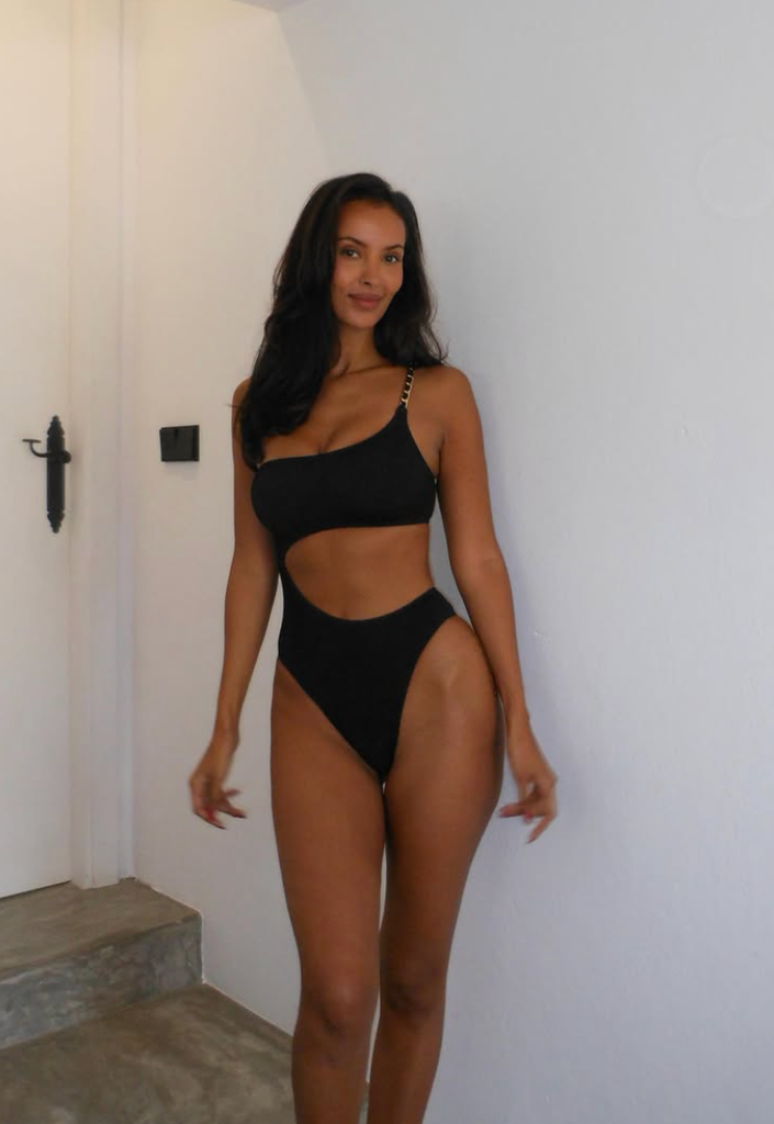 Maya Jama is all legs and poses as a scorching summer time pin-up in a tiny swimsuit and sky-high heels. 1 A photo of Maya Jama wearing a black cutout swimsuit