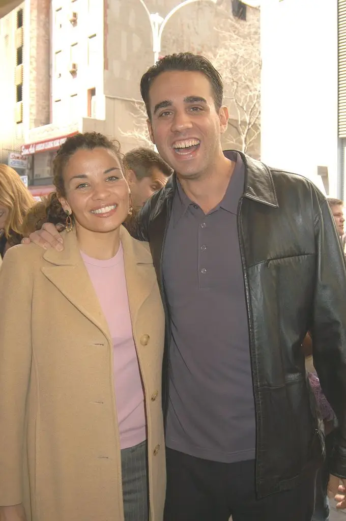 Actor Bobby Cannavale and his wife Jenny Lumet. Bobby wears a dark shirt and a black leather jacket, Jenny wears a pink knit top and a beige coat.