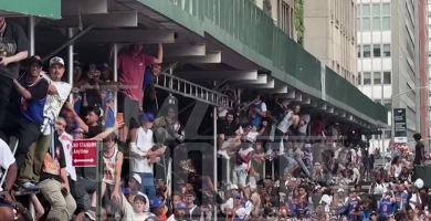 New York Knicks Madness fans climb scaffolding and lampposts to watch parade