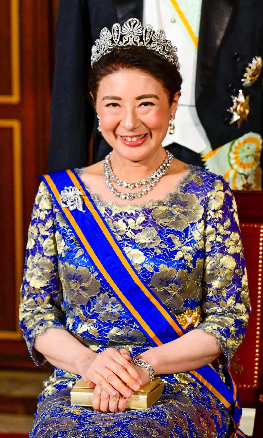 Empress Masako in a blue and gold dress with tiara