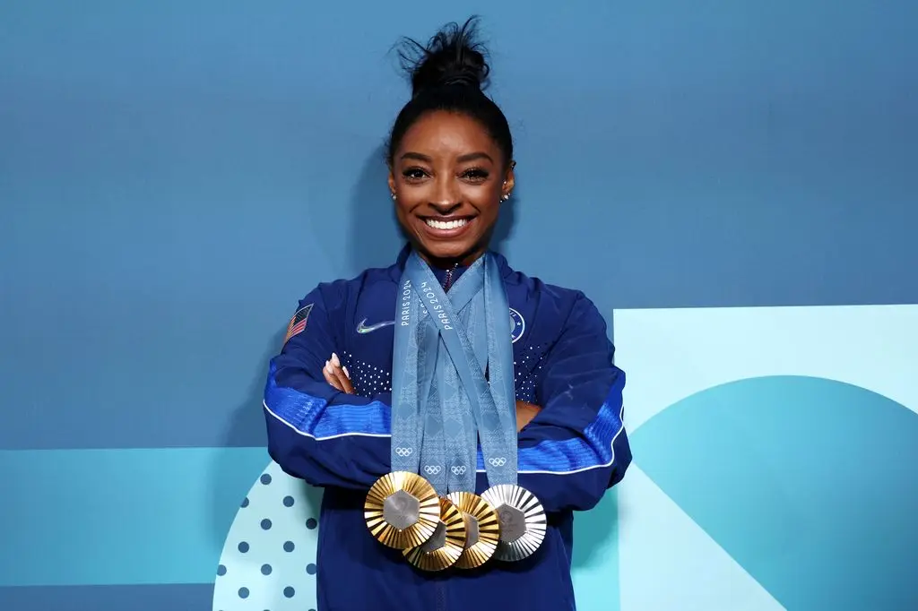 Simone Biles of Team USA poses with her Paris 2024 Olympic medals after the Artistic Gymnastics Women's Floor Exercise Final on the tenth day of the Paris 2024 Olympic Games at Bercy Arena on August 05, 2024 in Paris, France. 