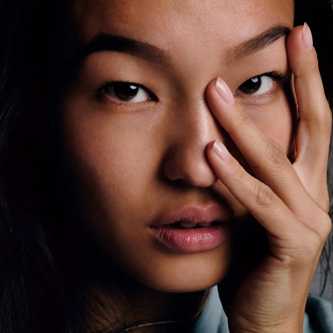 I attempted Japanese double hydration for a month 2 Close-up of calm Korean girl with smooth skin looking at camera with fingers on face