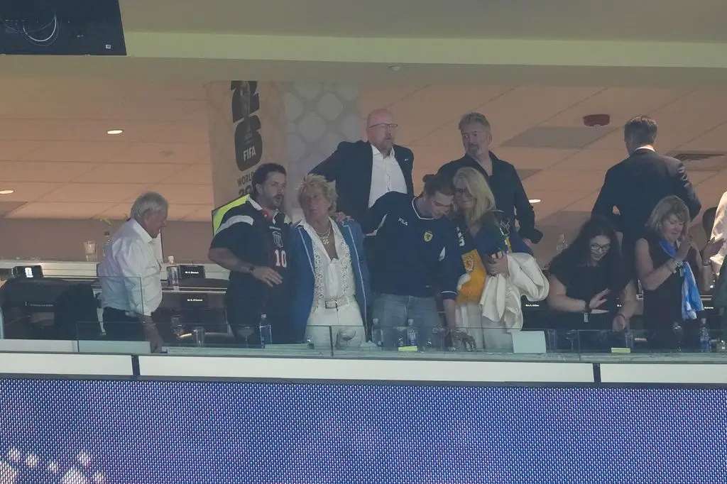Sir Rod Stewart (third from left) celebrates in the stands 