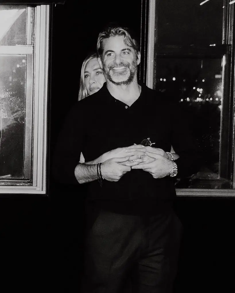 Jennifer Aniston and Jim Curtis kiss in a snap taken at the latter's 50th birthday party, shared on Instagram