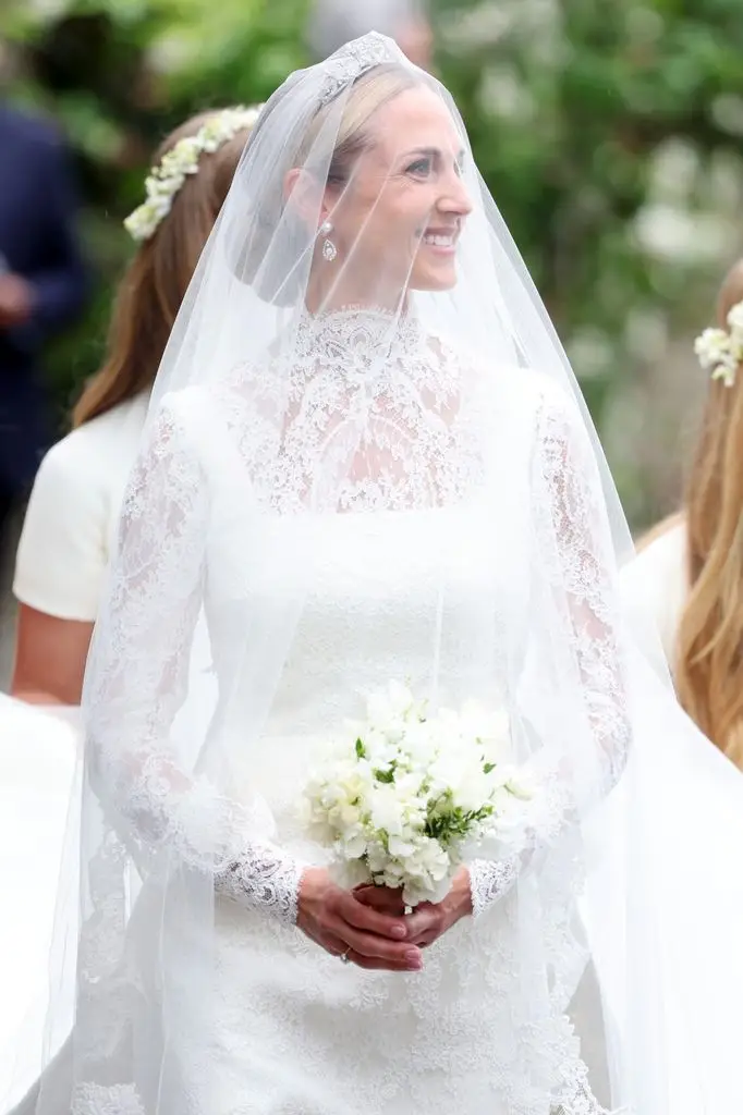 Peter Phillips and Harriet Sperling share their first romantic kiss after a fairytale marriage ceremony 1 Harriet Sperling smiles, wearing a white wedding dress and veil, holding flowers