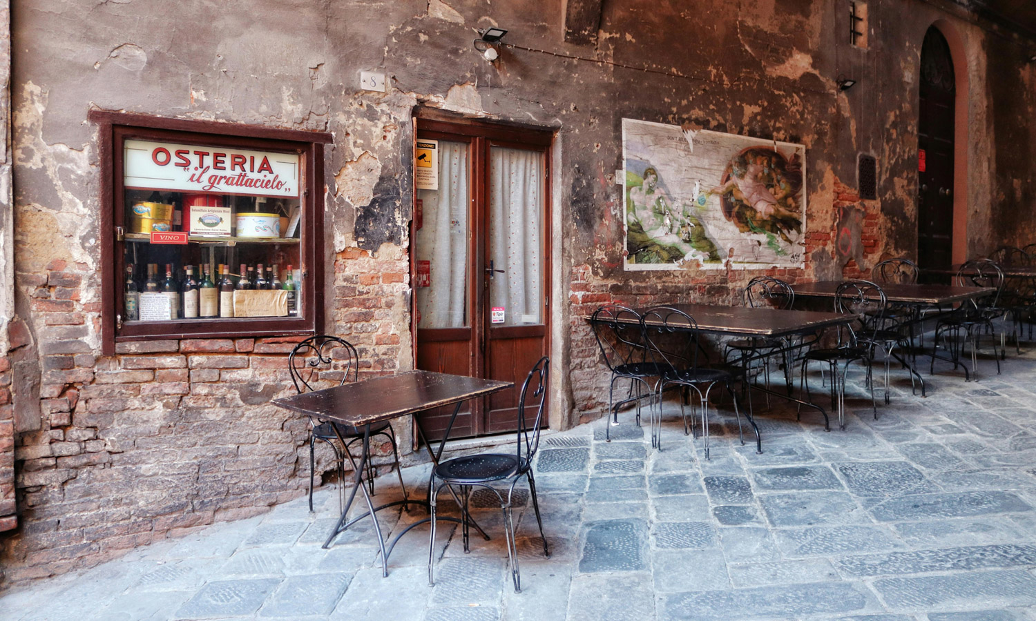 Italian court docket permits eating places to refuse to offer free water to prospects 2 Vintage beer garden with empty tables in historic Italian street.