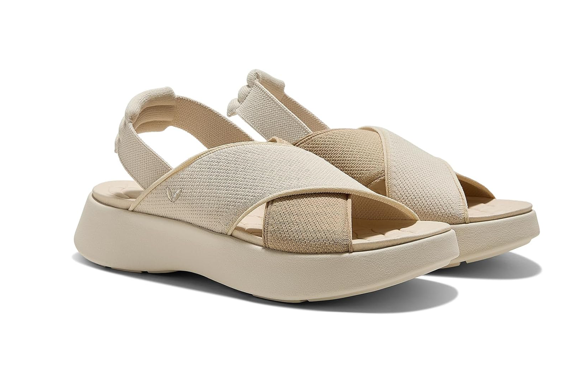 Pair of cream and beige platform sandals with crossed straps.