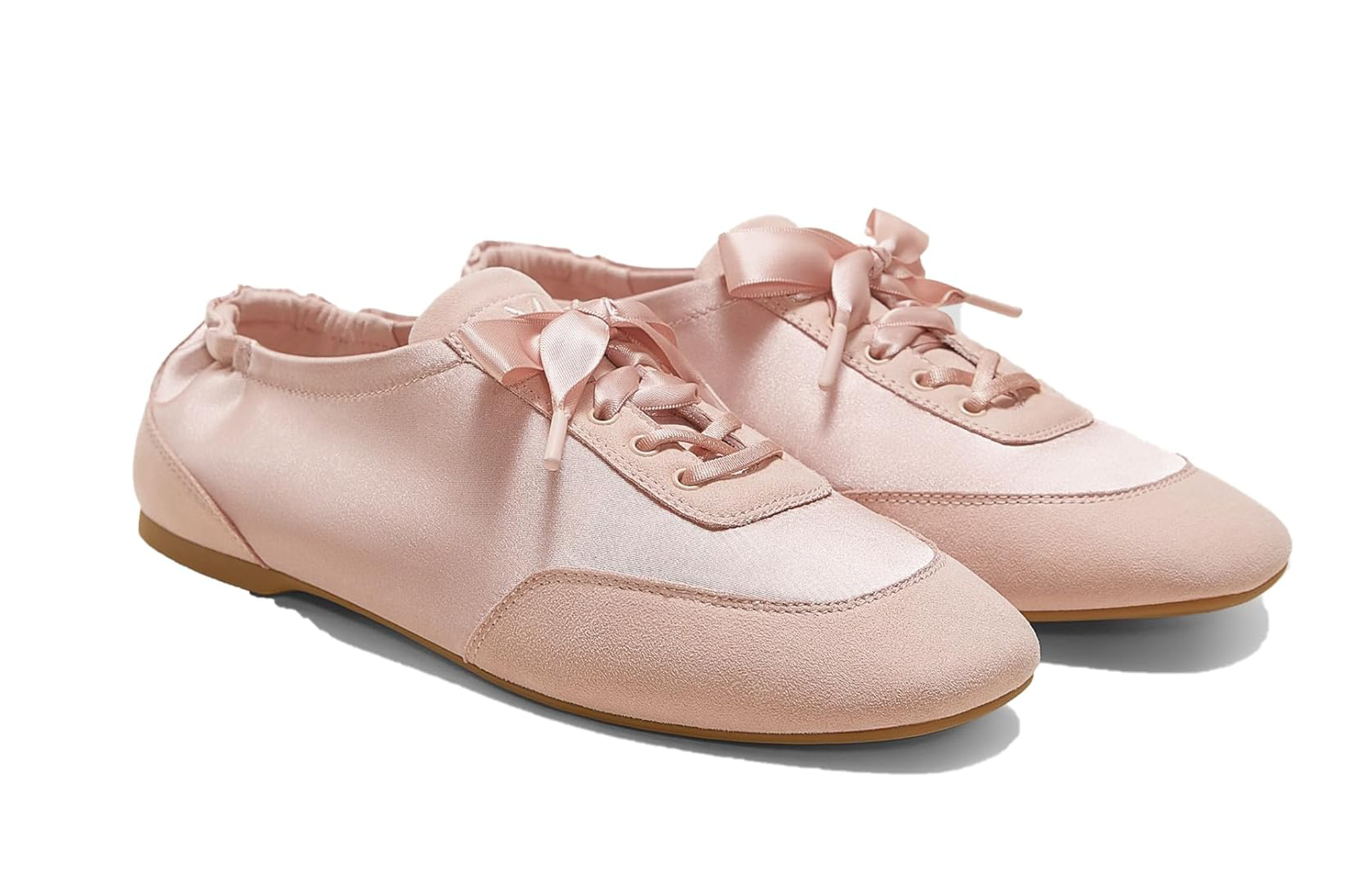 Pair of pink satin sneakers with ribbon laces and suede details.
