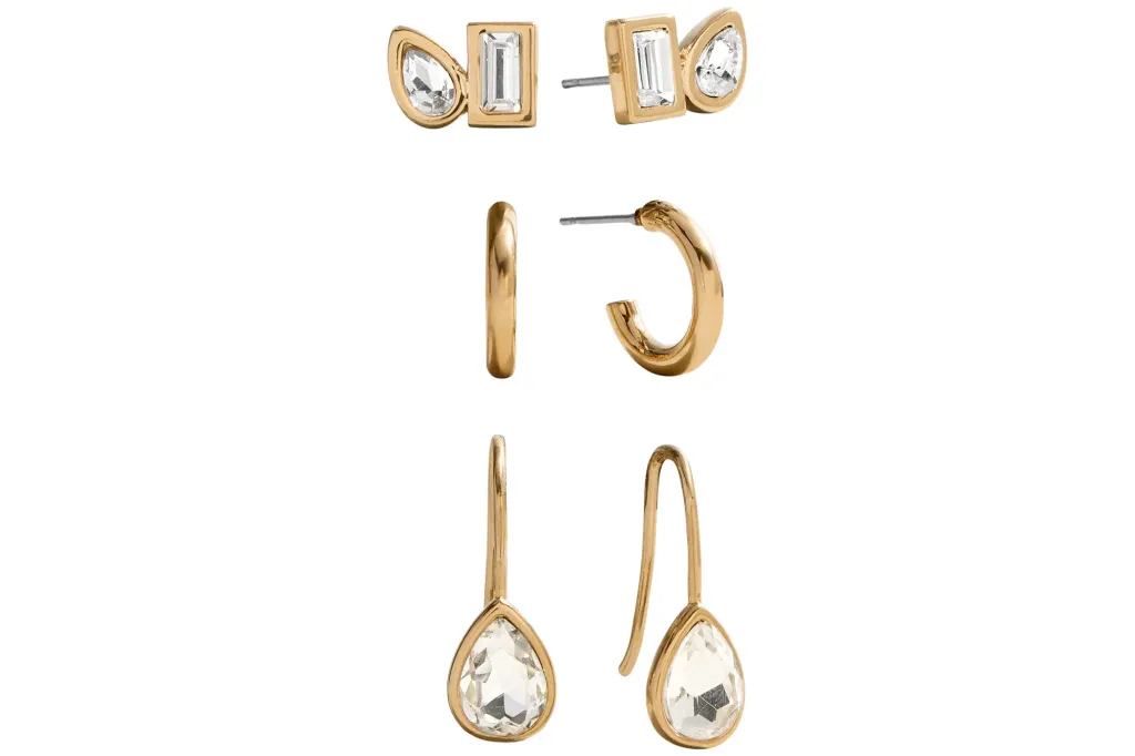 Nordstrom's Anniversary Sale has celebrity-worn jewellery discounted as much as 35% off 3 Collage of three pairs of gold earrings, including crystal studded earrings, small gold hoop earrings, and gold dangling earrings with clear teardrop crystals.