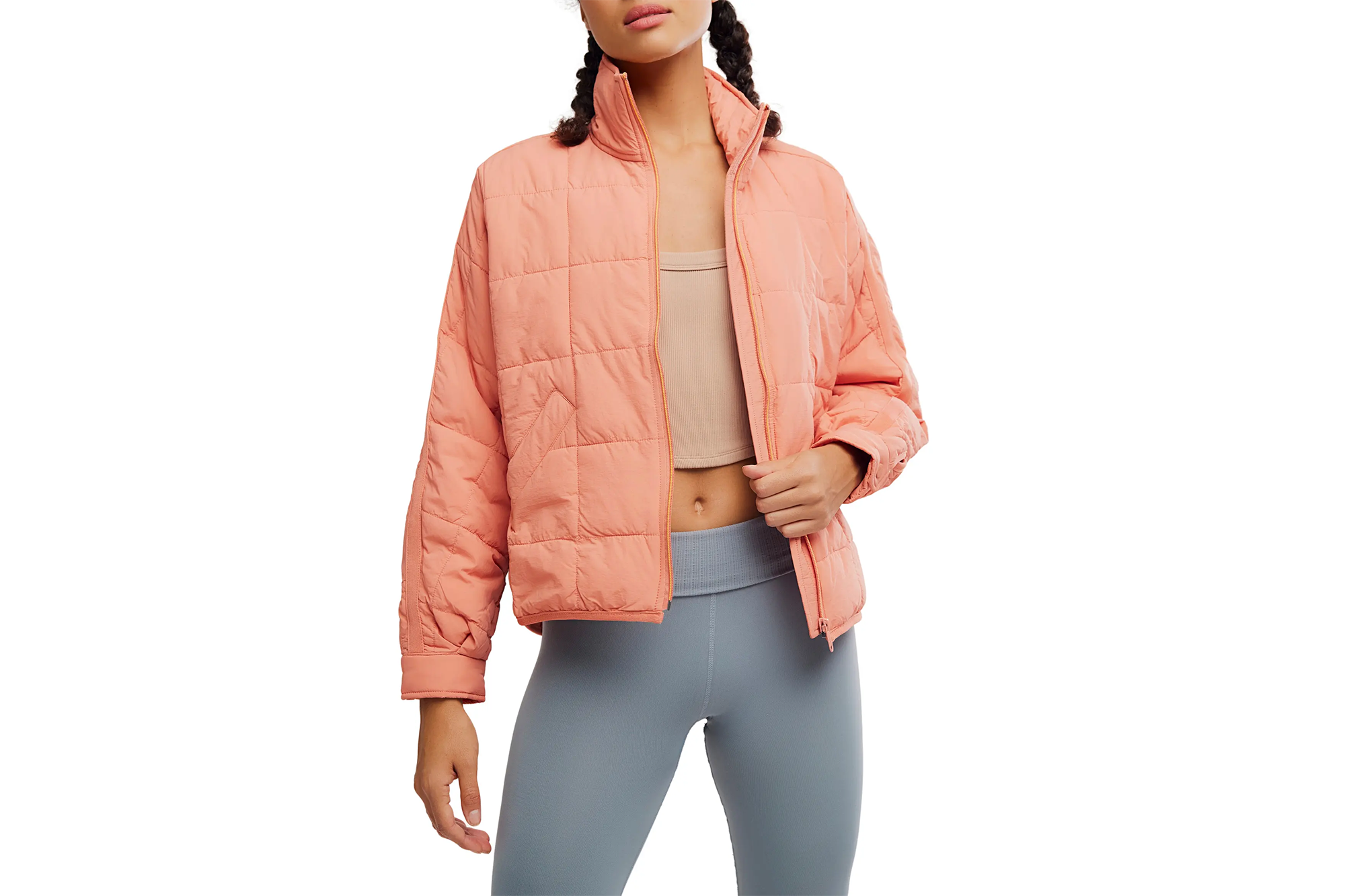 Nordstrom Anniversary Sale Has Nice Free Folks Offers 2 A woman wears a peach quilted jacket over a beige cropped top and gray leggings.