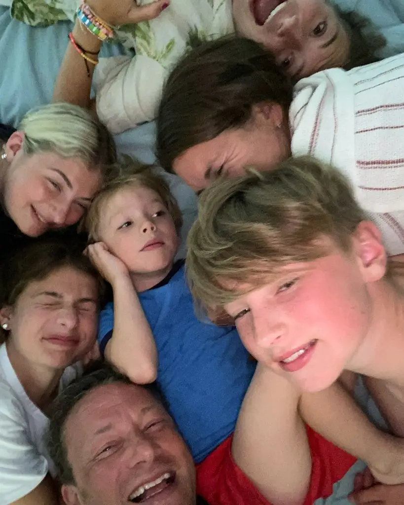 Jamie Oliver lying with his children