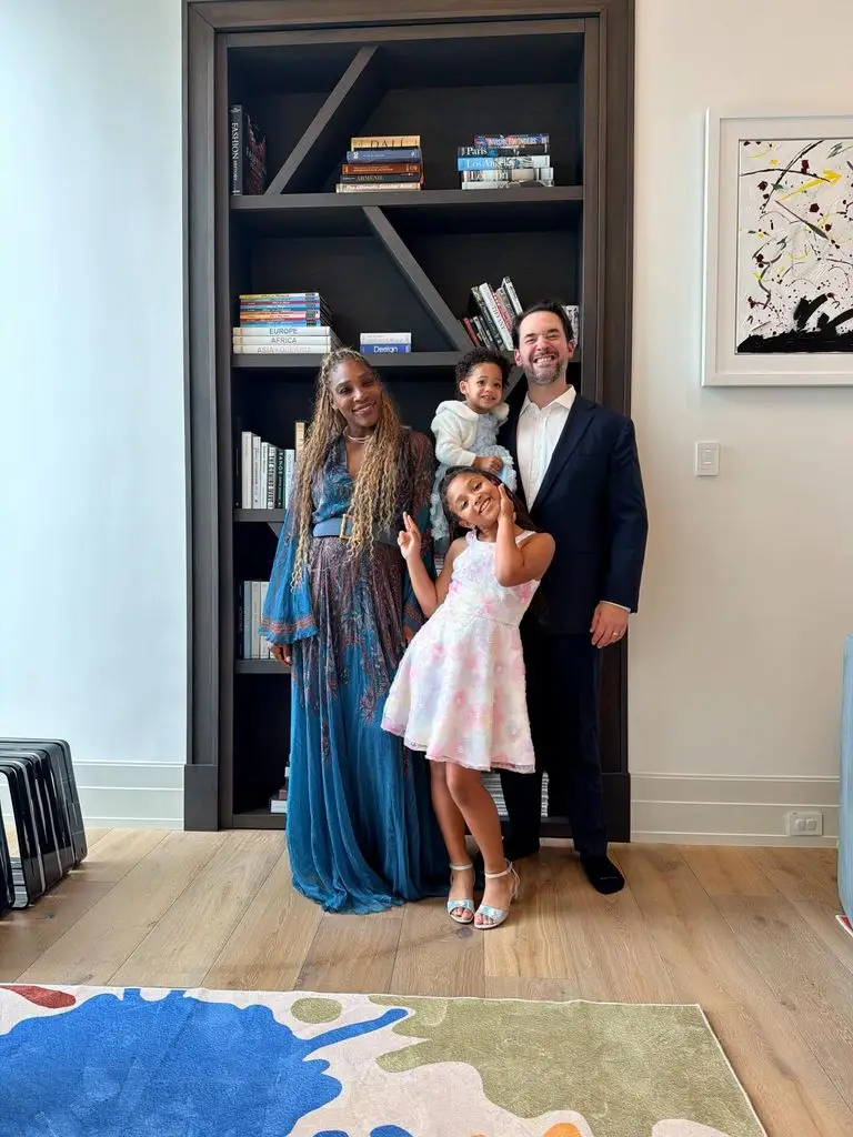 photo of Serena Williams with her daughters and her smiling husband