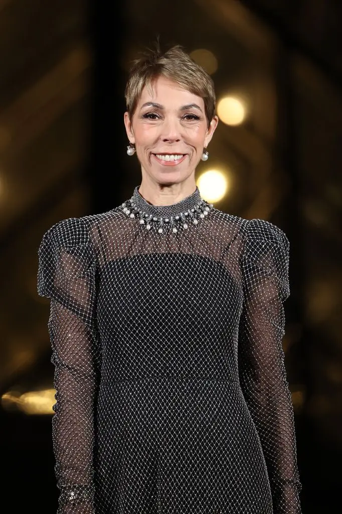 Claudia Schiffer, Beatrice Borromeo and Carla Bruni collect to bid farewell to Dior public relations supervisor Mathilde Favier at funeral in Paris 3 A smiling woman with short hair wearing a sparkling black dress and a pearl necklace.