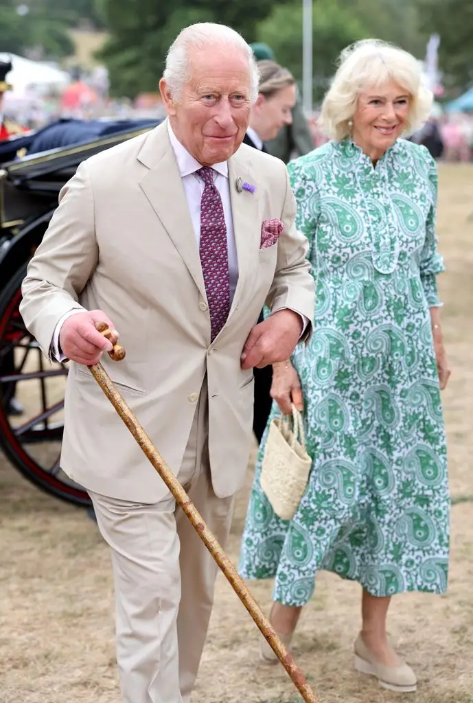 King Charles III and Queen Camilla smile as they arrive for the first RHS Sandringham Flower Show at the Royal Sandringham Estate 