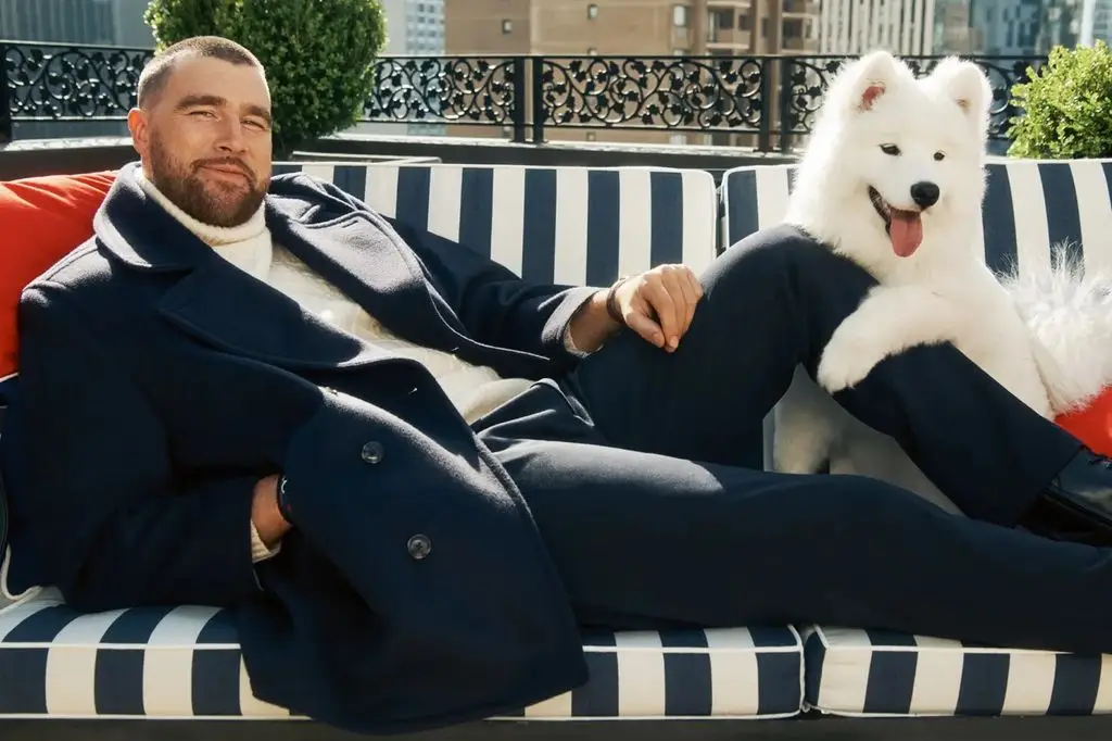 Taylor Swift and Travis Kelce's Gorgeous $5.35 Million Mansion Revealed 2 Travis Kelce is lying on a striped couch with his white Samoyed resting on his lap.