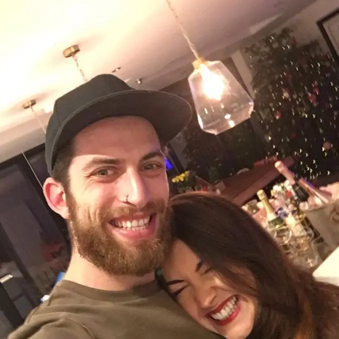 Meet Strictly star Lacey Turner's 3 children she shares along with her husband after tragic miscarriages 1 Man with beard and cap smiling with Lacey Turner, both laughing in a festive setting.