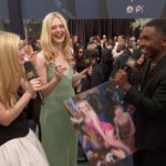 Dakota and Elle sign a photo of them partying.