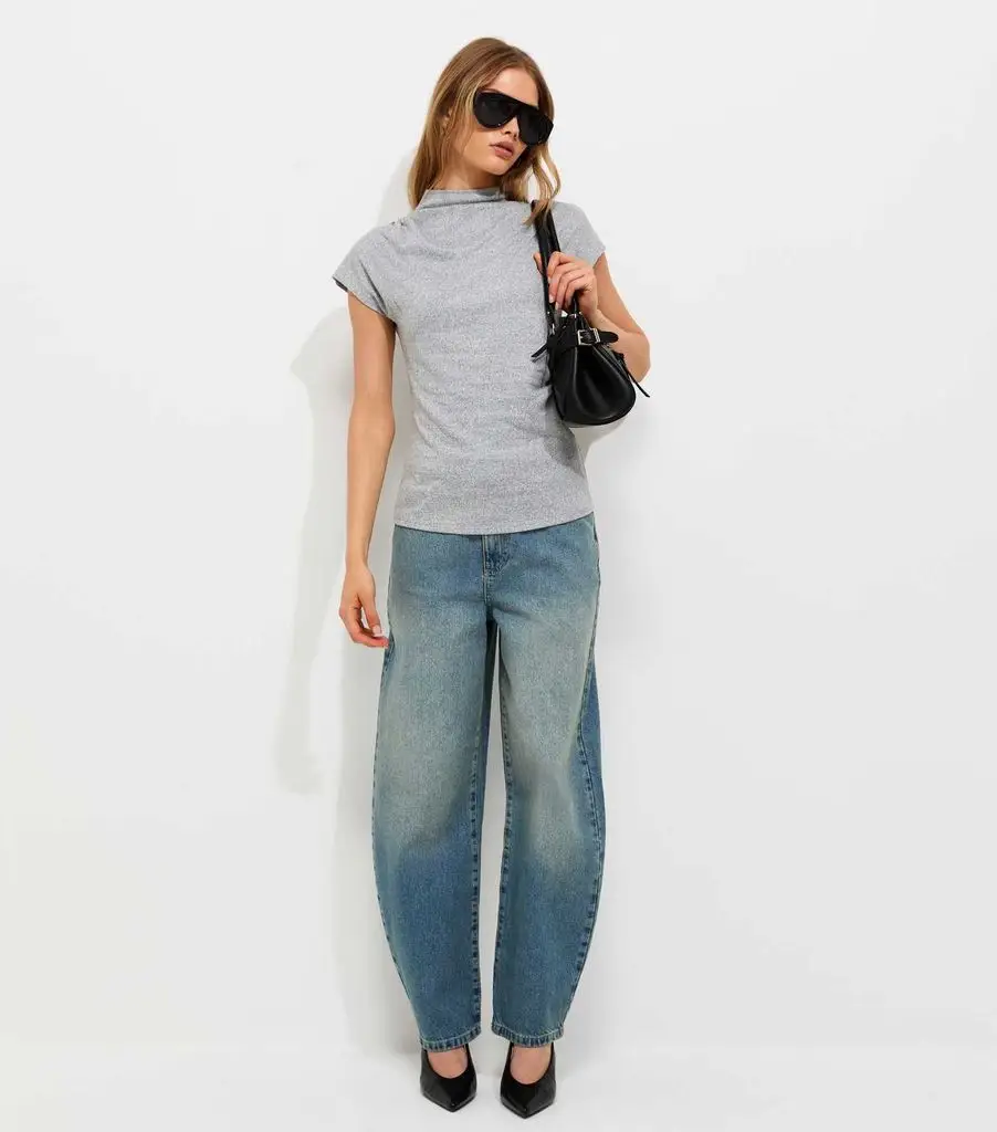 model in gray t-shirt and sculpting jeans