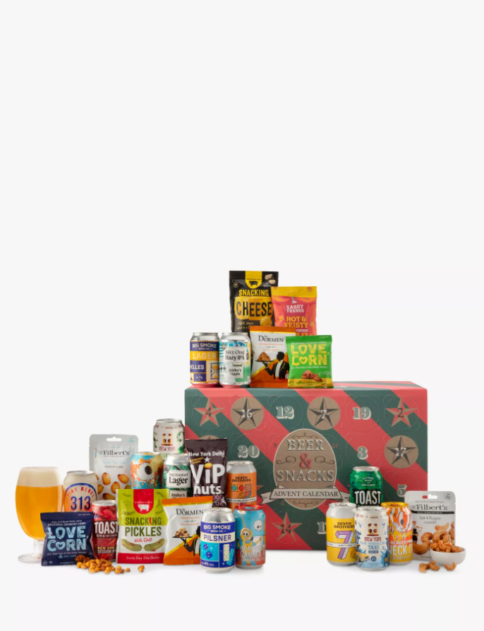 John Lewis Beer & Snacks Advent Calendar featuring an assortment of snacks and drinks including cheese, corn and beer arranged on a table.