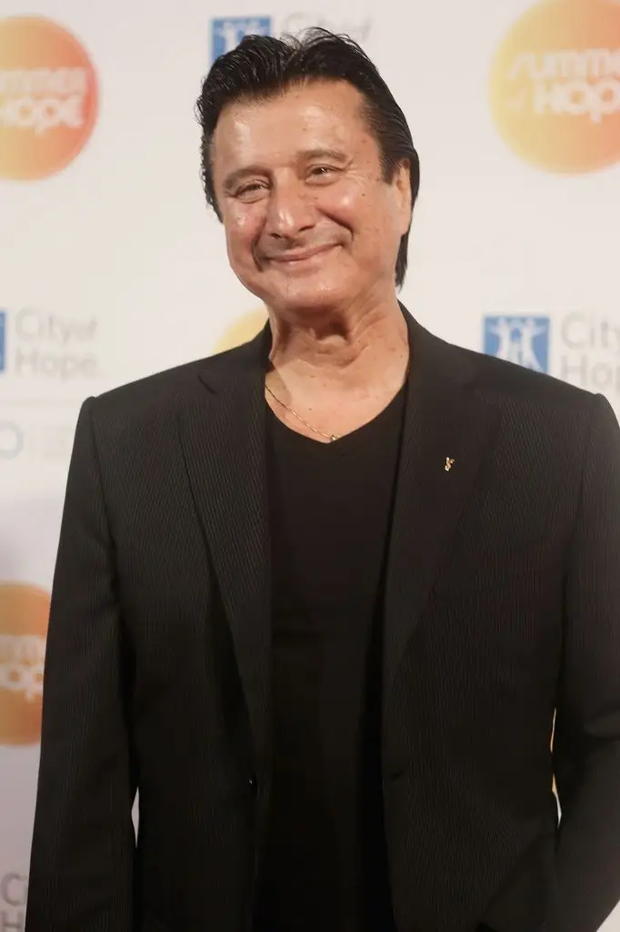 What occurred to Do not Cease Believin' singer Steve Perry? In his solitary life, removed from the highlight 3 A smiling Steve Perry, dressed in a black suit and black shirt, at an event.