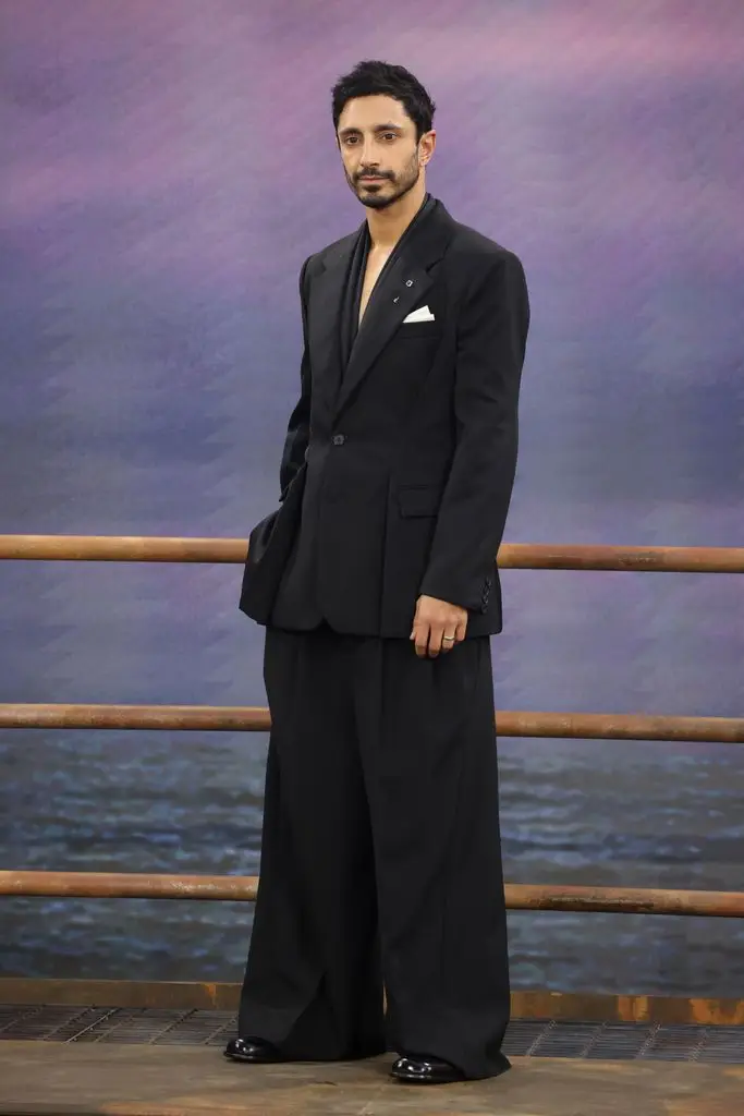 Riz Ahmed in a suit with wide pants