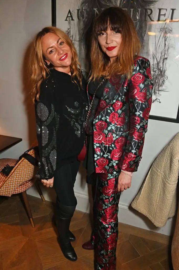 Inside Jaime Winstone's Off-Display screen Life: From Emmy-Profitable Dad to Well-known Ex Linked to British Pop Royalty 2 Two women, one in a black sequined top and black pants, the other in a red floral suit, standing together.