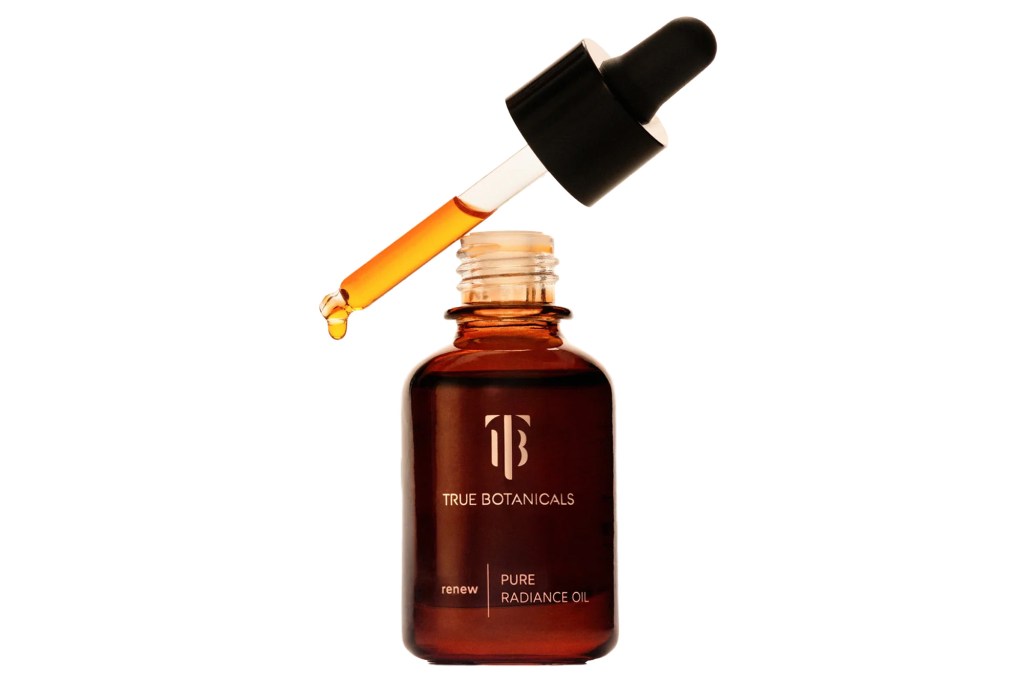 True Botanicals Renew Pure Radiance Oil in an amber bottle with a dropper.