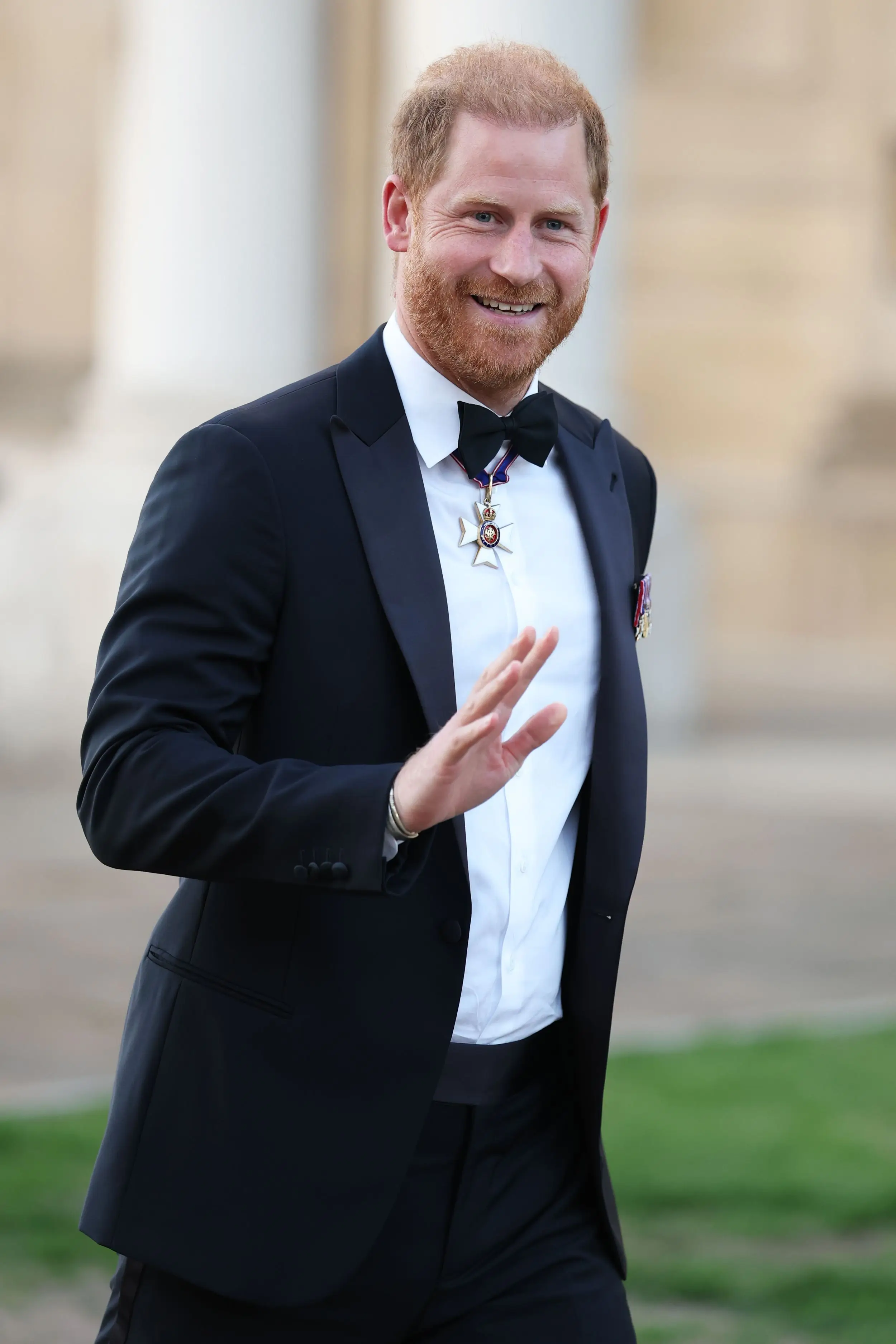 How Prince William and Prince Harry are navigating new household turmoil 3 Prince Harry, Duke of Sussex, in black tuxedo with medals, smiling and gesturing.
