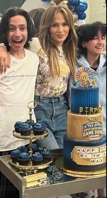 photo of Jennifer Lopez with twins Max and Eme standing behind a birthday cake