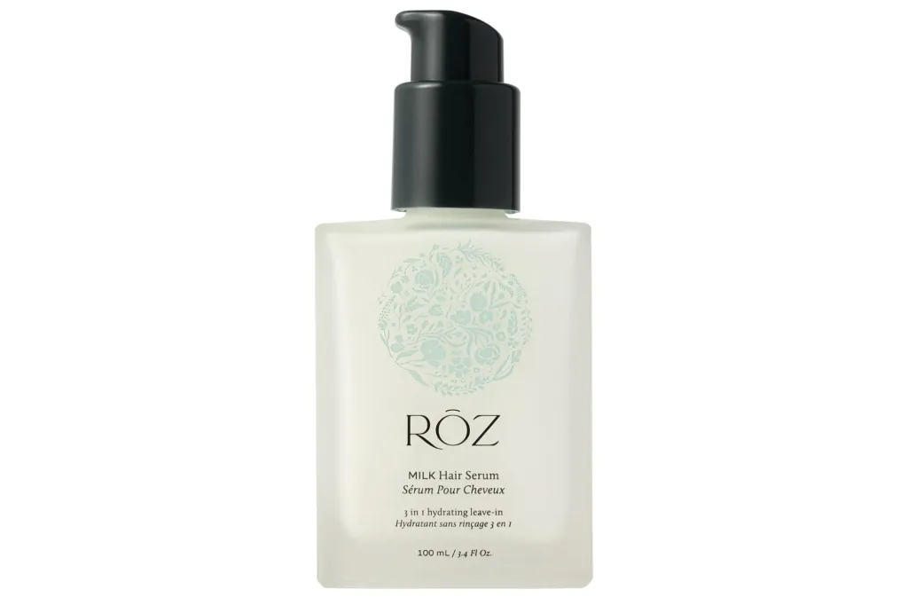A white bottle of RÓZ Milk Hair Serum with a black pump cap.
