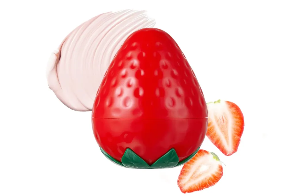 Strawberry-shaped beauty product with a layer of cream and two strawberry halves.