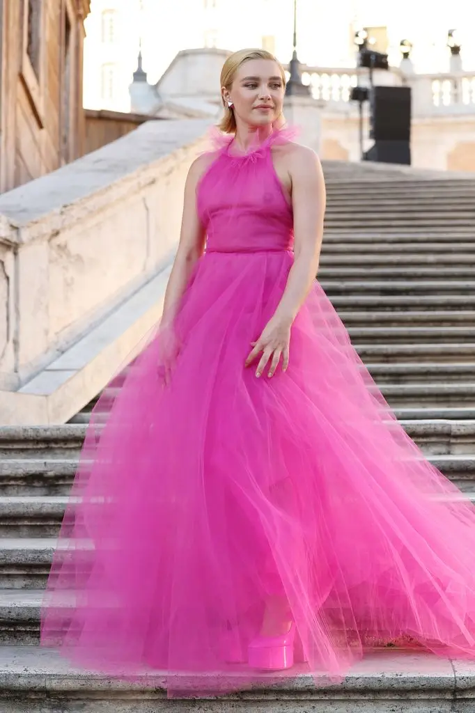 Florence Pugh stuns in plunging silver corset costume as she makes crimson carpet debut with boyfriend 3 Florence Pugh attends the Valentino Haute Couture fall/winter 22/23 show in a pink transparent dress