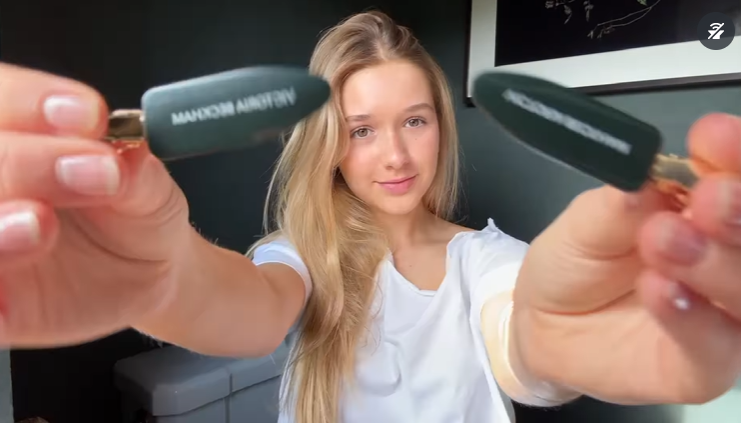 Harper holds hair clips on camera