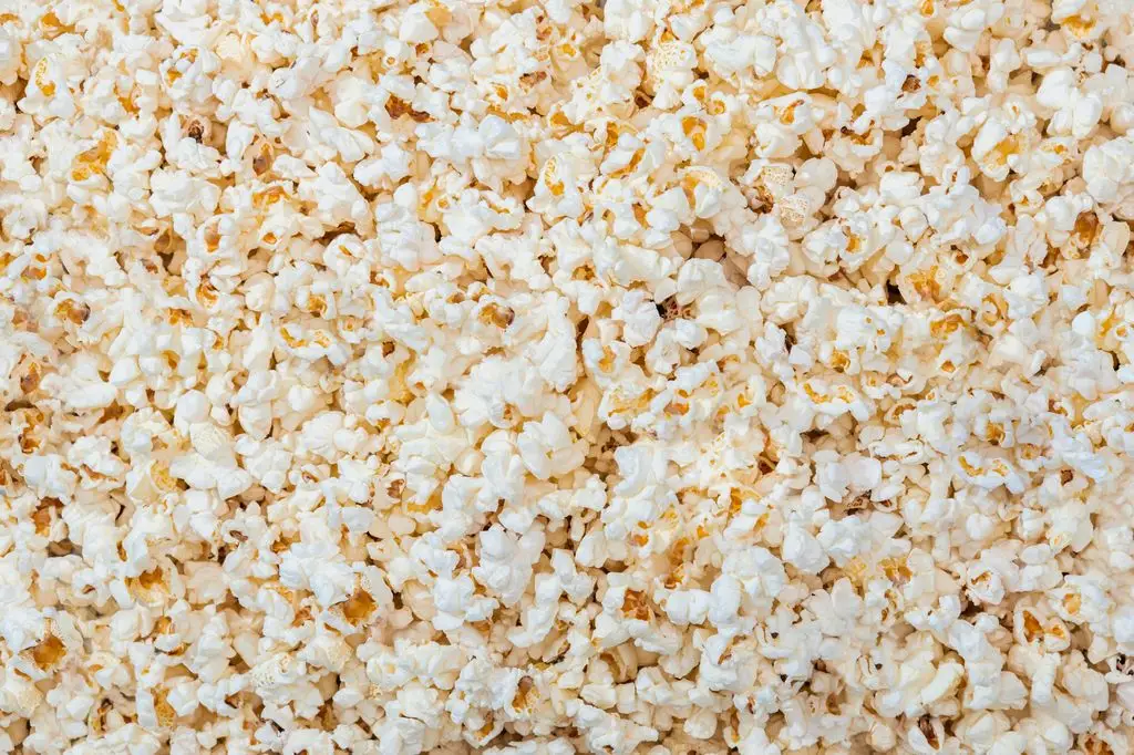 A dense overhead view of freshly popped popcorn filling the entire frame.