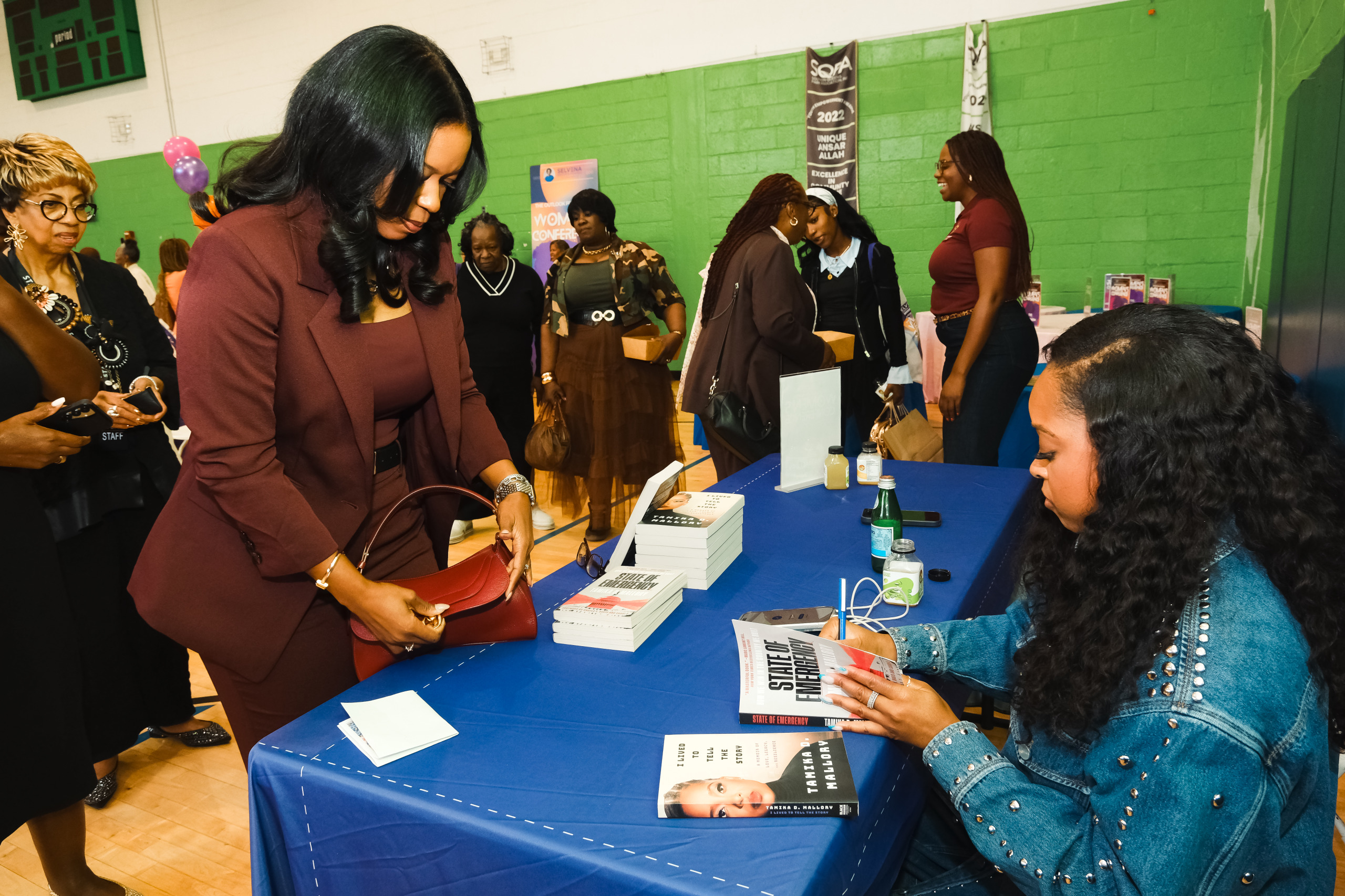 Tamika D. Mallory signs her books at the conference. (Photo credit: Shellessa Constantine)