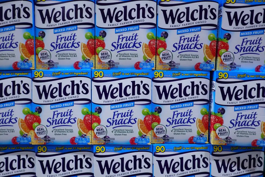 Rows of stacked boxes of Welch's Mixed Fruit Snacks fill the frame of a store shelf.