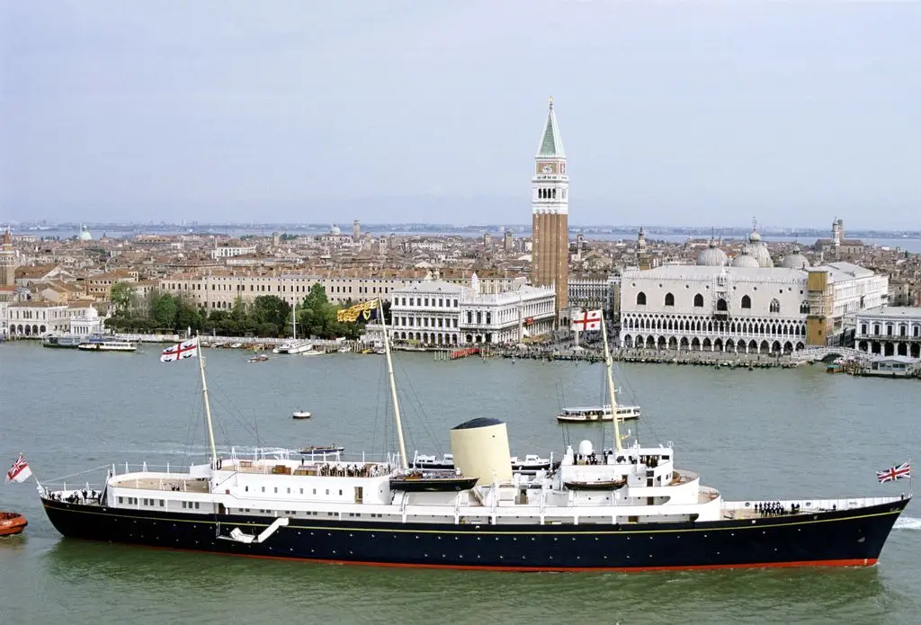 The Royal Yacht Britannia sails through Venice