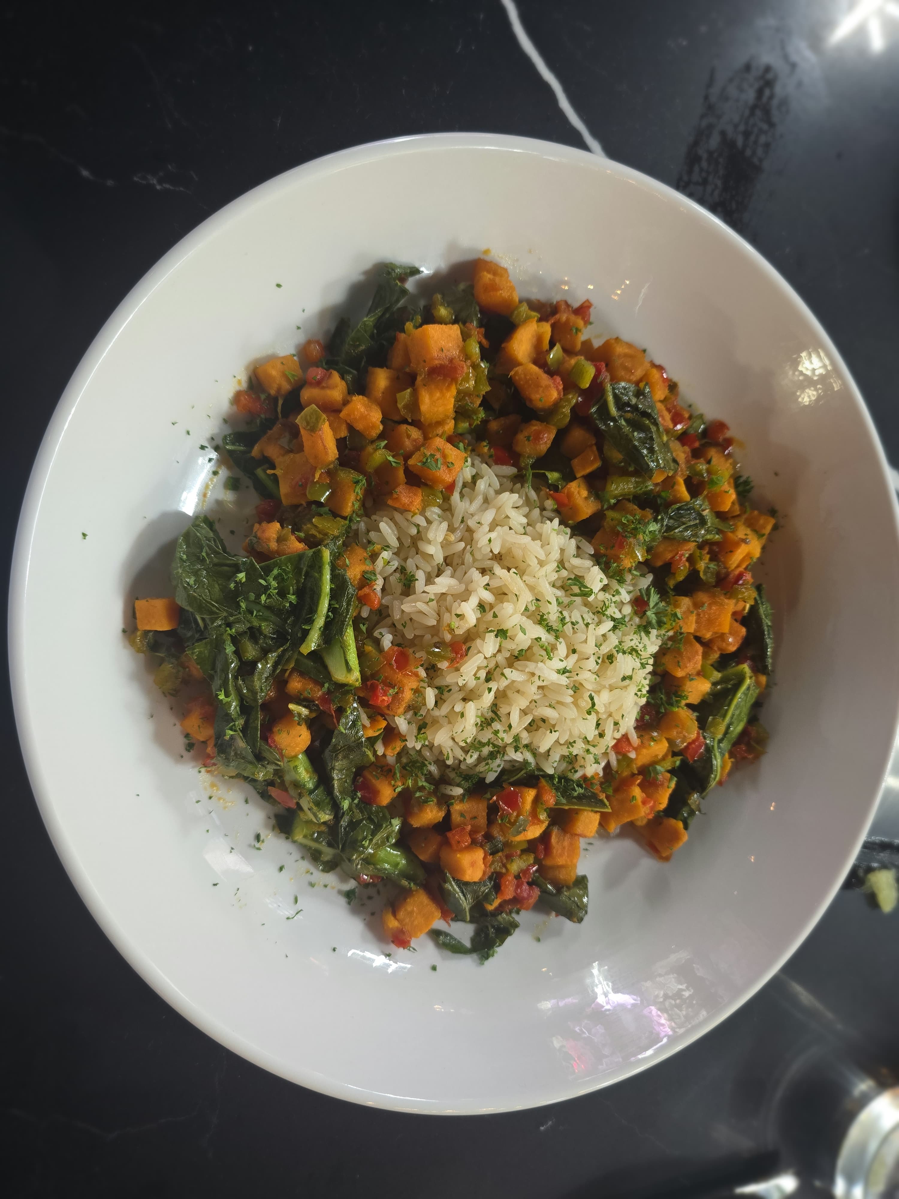 Kitchen + Kocktails Expands to NYC: HBCU Grad Kevin Kelley Provides First Look to ESSENCE 1 The K+K Vegan Bowl is a modern take on Southern staples like candied yams, collard greens and dirty rice.